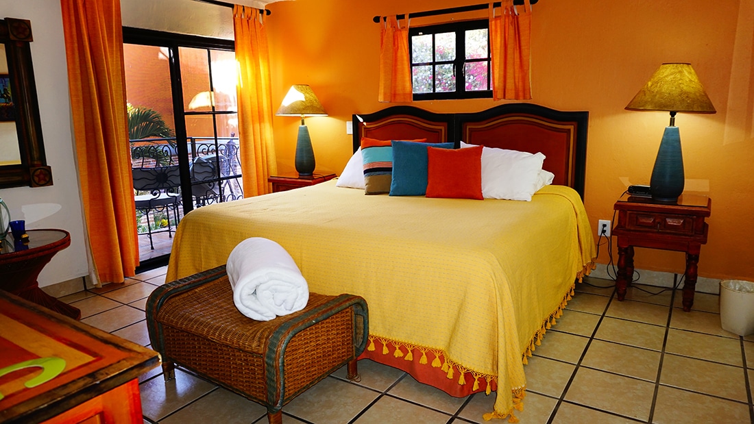 El Jardin bed with colorful pillows