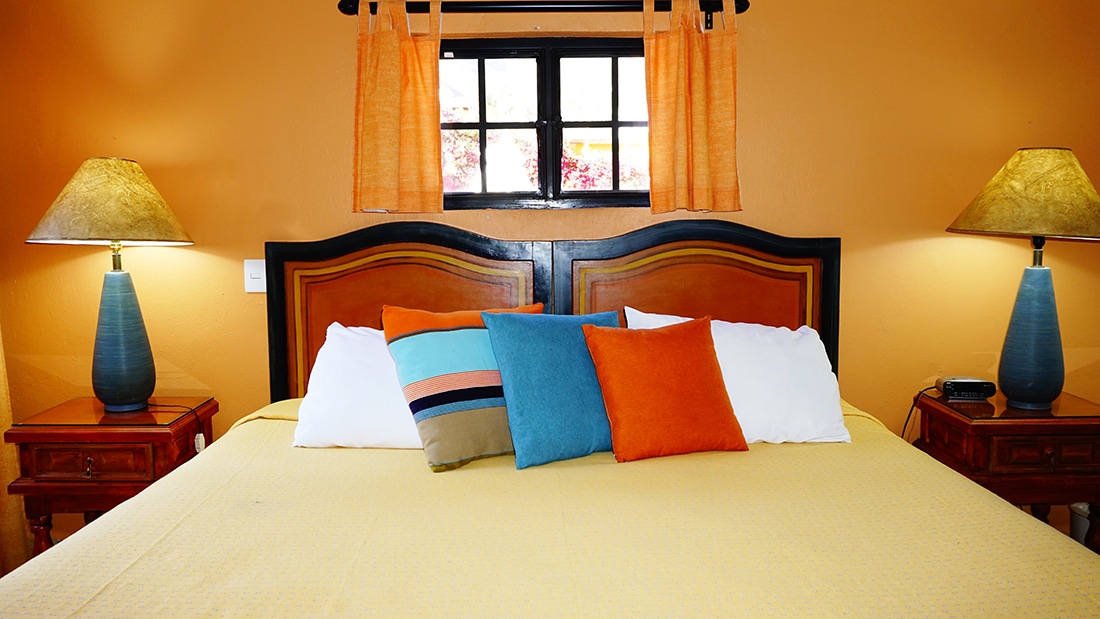 Upclose view of colorful pillows on bed