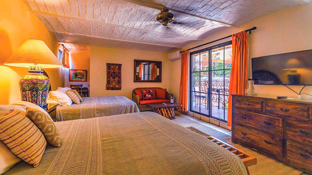 Room 7 beds and wicker couch